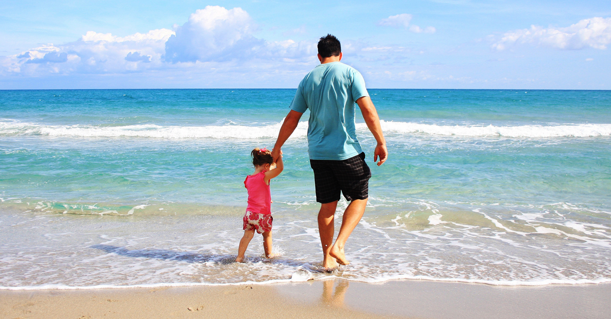 dad walking with daughter on the beach holding hands | co parenting tips