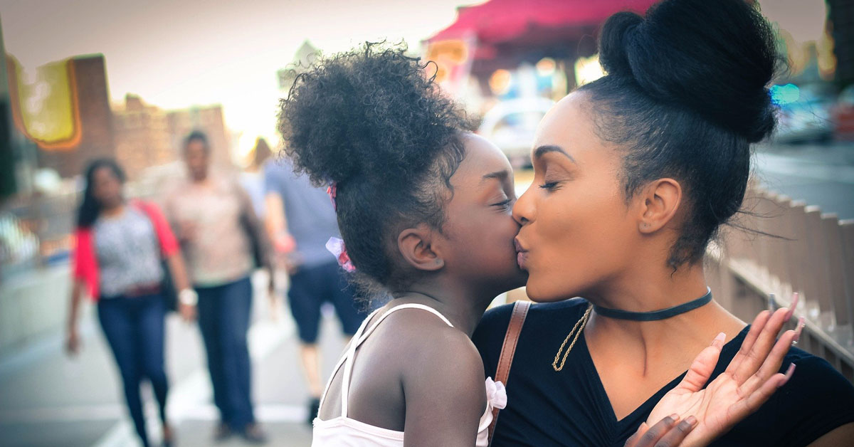 mother is kissing and has custody of daughter