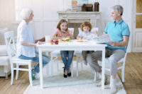 grandparent custody - Friendly family of four having their meal