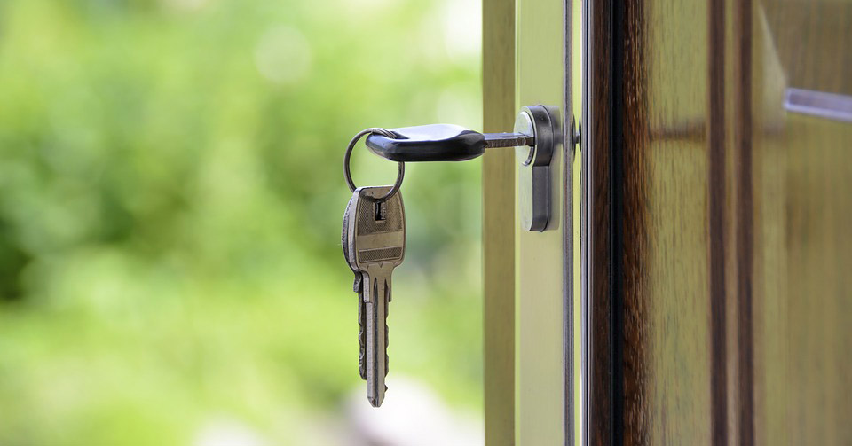 keys in the lock of an open front door