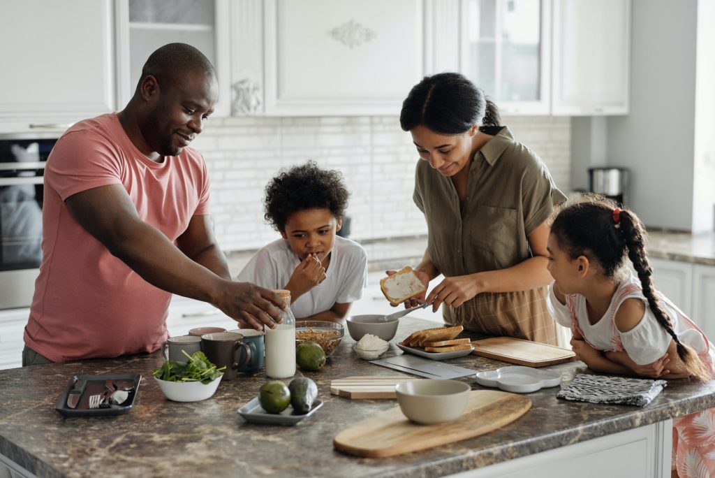 Family gathered around a kitchen island. Family lawyers help and support families of all types. 