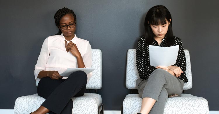 2 women reading a new workplace policy on sexual harassment