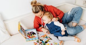 mother and daughter playing a game on the couch